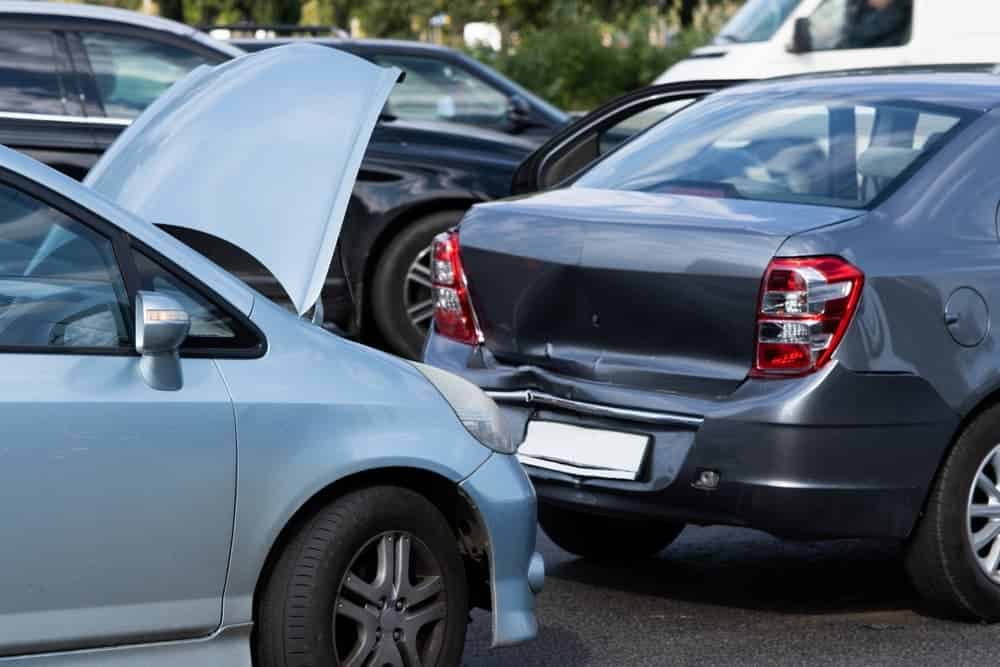 Two cars after a street collision reflect damage requiring auto body repair procedures