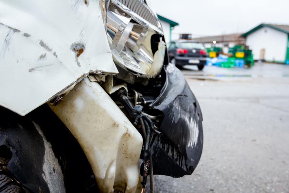 Front section of a car showing crumple zone deformation after a collision impact